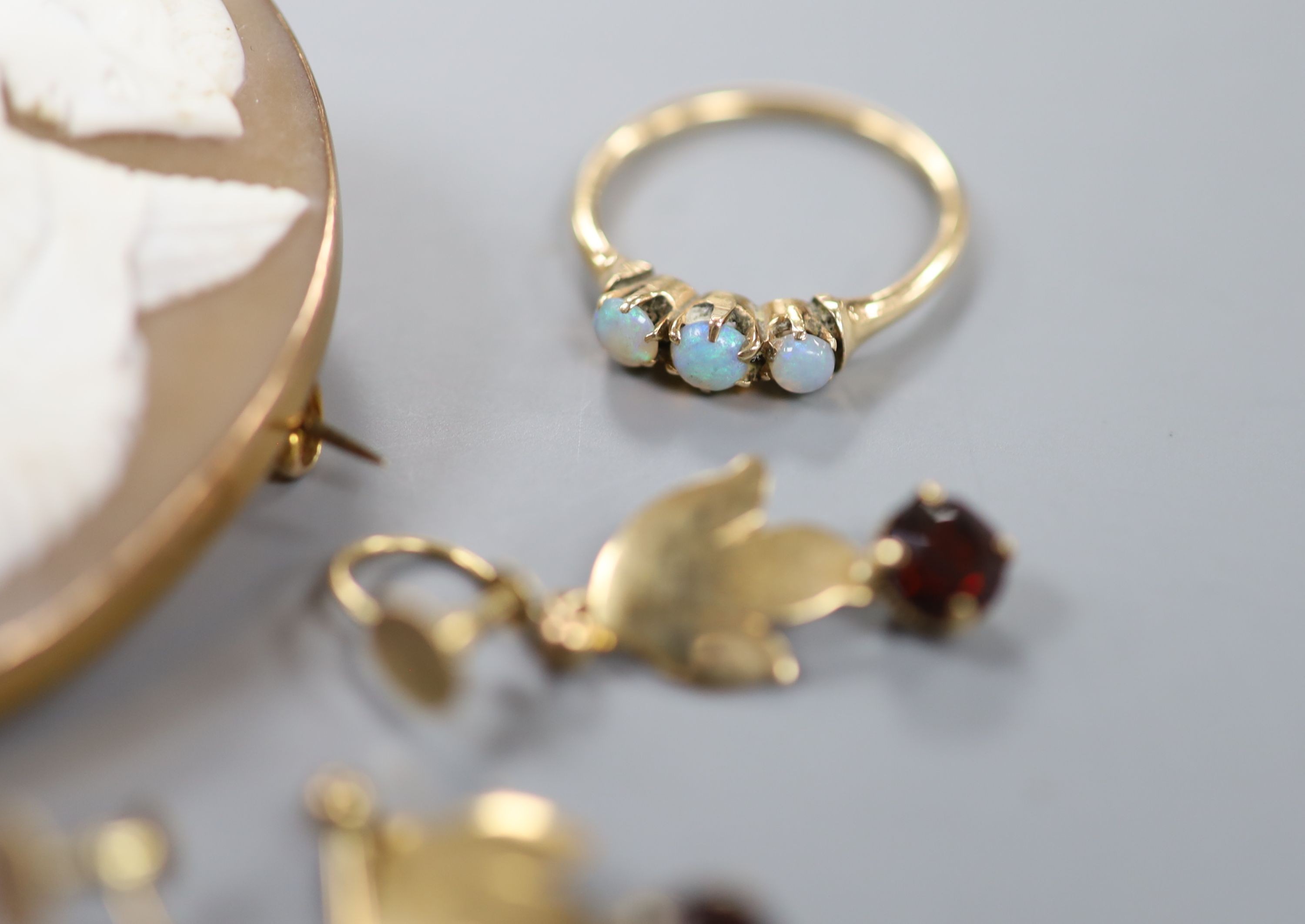 A 9ct gold and citrine set ring, two other gem set rings, a 9ct mounted cameo brooch, a yellow metal and gem set bar brooch and a pair of 9ct gold and gem set drop earrings.